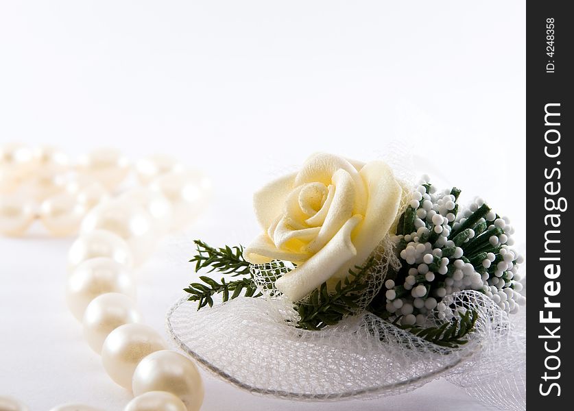Pearl necklace and wedding rose macro white background