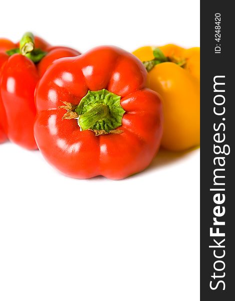 Fresh Red and Yellow Bell Peppers isolated on a white background. Fresh Red and Yellow Bell Peppers isolated on a white background.