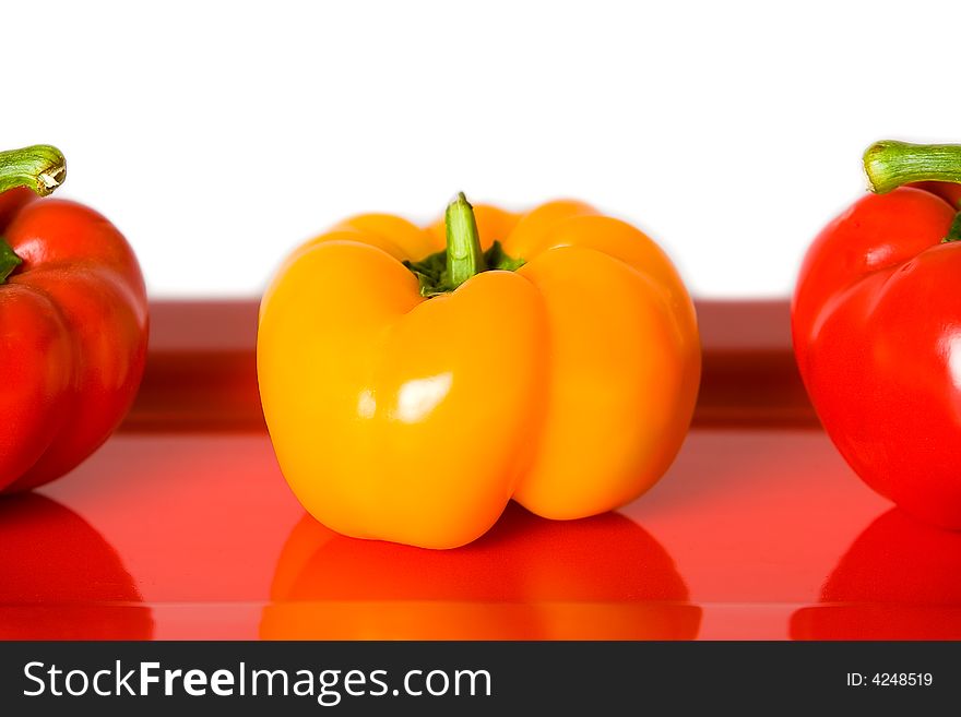 Closeup of Red and Yellow Bellpeppers on a white background. Closeup of Red and Yellow Bellpeppers on a white background.