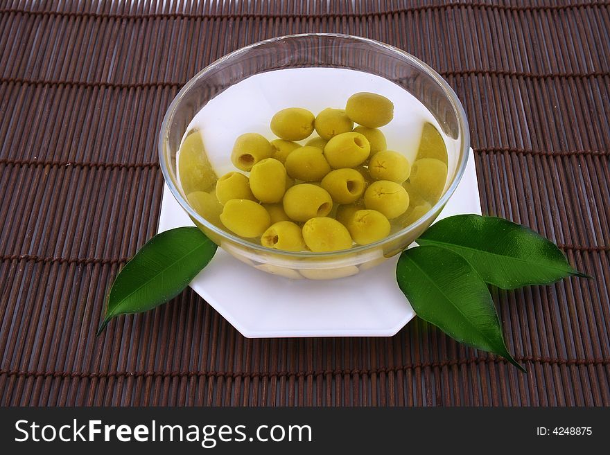 A small bowl of olives on a table