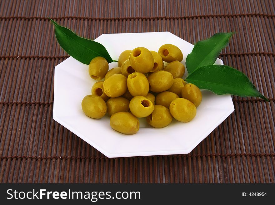 A small bowl of olives on a table