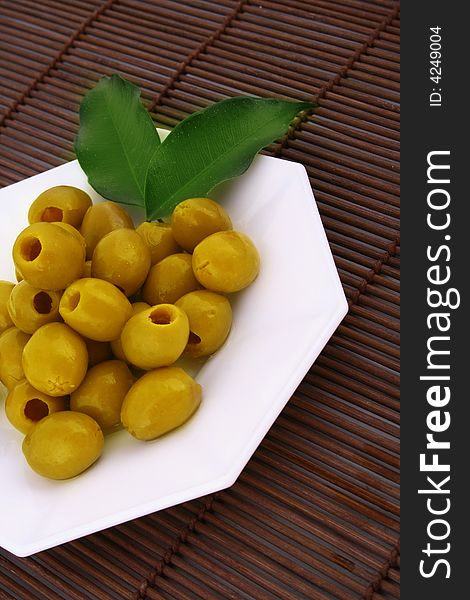 A small bowl of olives on a table