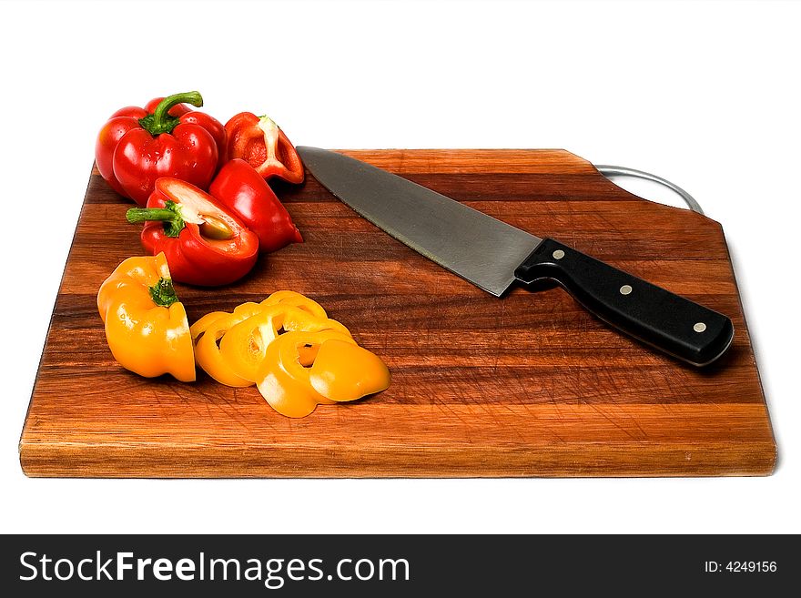 Sliced yellow and red Bell Peppers on cutting board with knife. Sliced yellow and red Bell Peppers on cutting board with knife.