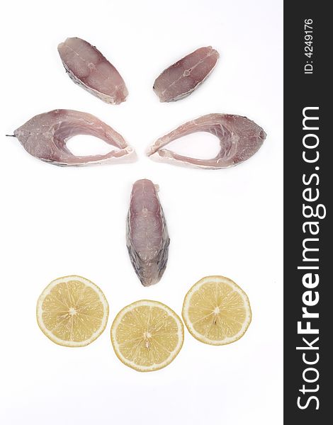 Smiley face made out of slices of fish and lemon isolated on white background
