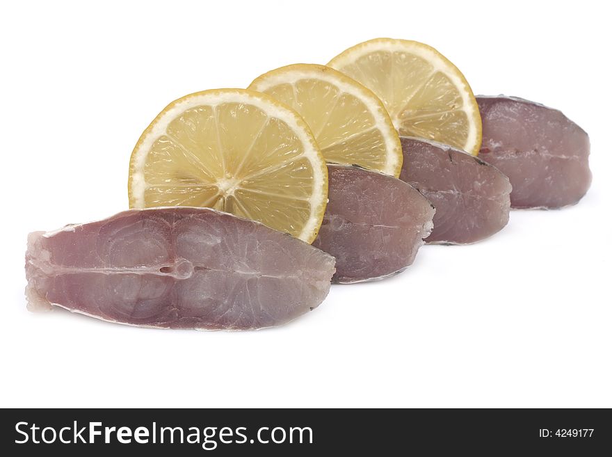 Slices of fish and lemon isolated on white background