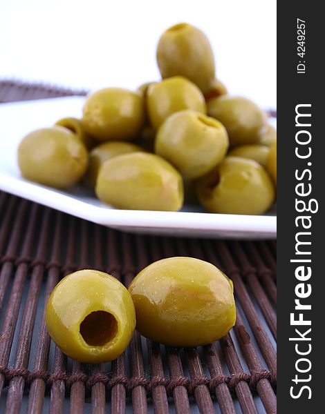 A small bowl of olives on a table