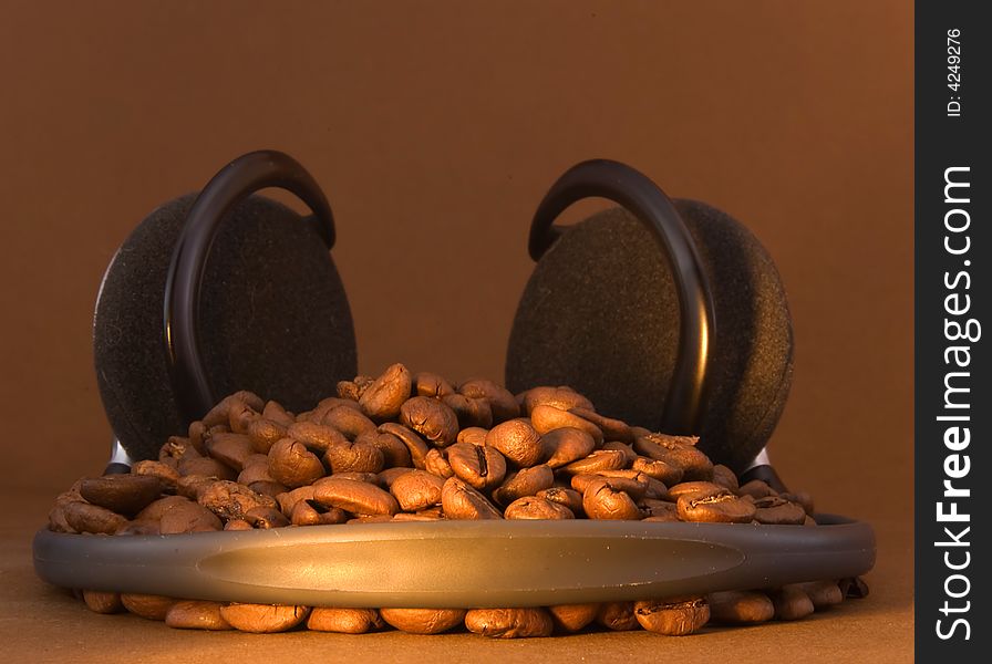 Coffee beans in embrace of headphones. Coffee beans in embrace of headphones