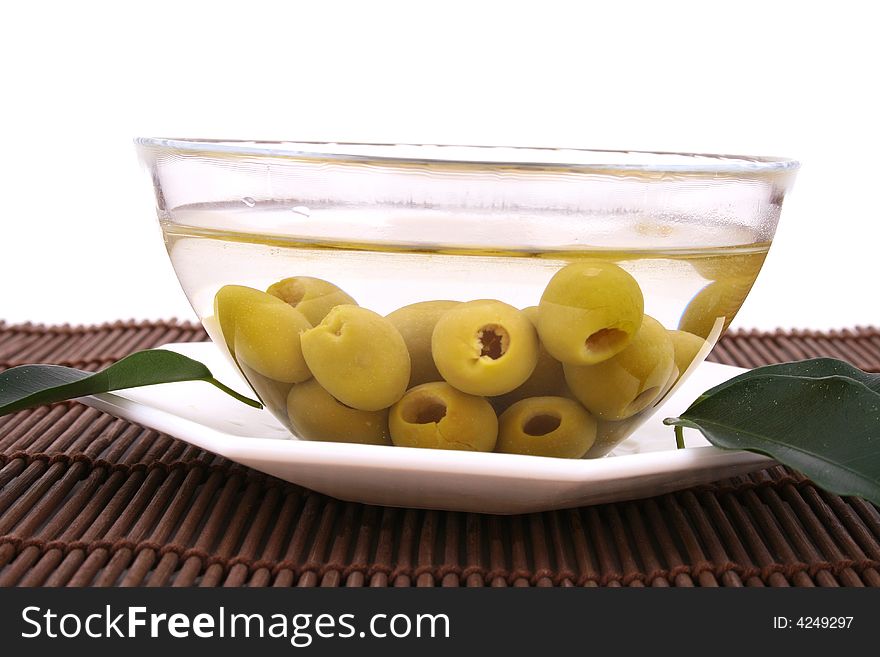 A small bowl of olives on a table