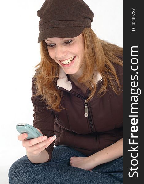 Young woman sitting and smilling with cell phone. Young woman sitting and smilling with cell phone