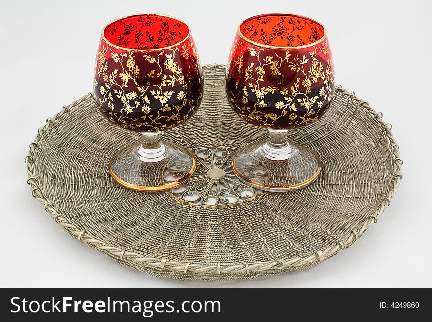 Two glasses with wine on a wattled metal tray
