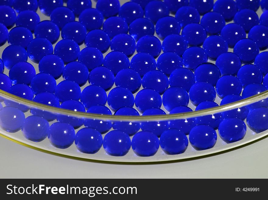 Blue pills in a Petri dish, close-up, shallow depth of field. Blue pills in a Petri dish, close-up, shallow depth of field.