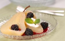 Pear Poached In White Wine With Blackberry Sauce Stock Images