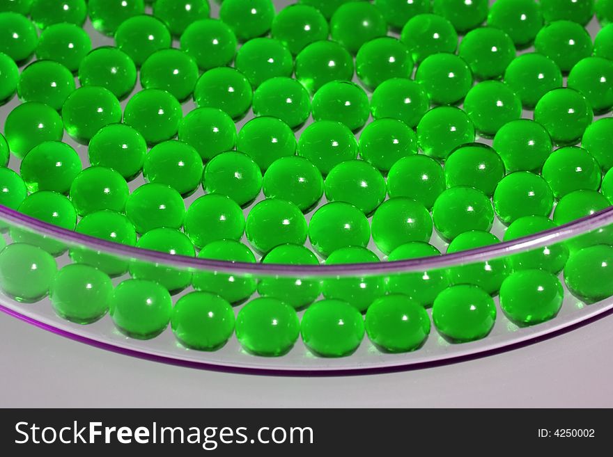 Green pills in a Petri dish, close-up, shallow depth of field. Green pills in a Petri dish, close-up, shallow depth of field.