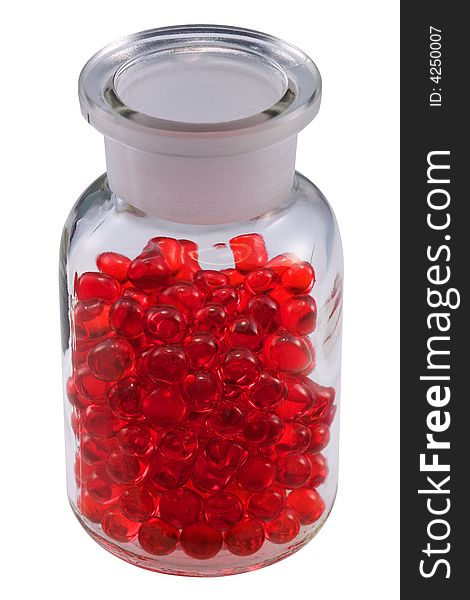 Red pills in a vial, isolated on white.