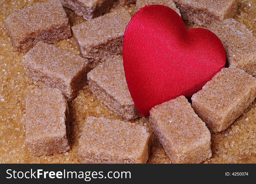 Close up on a brawn sugar cubes with heart. Close up on a brawn sugar cubes with heart