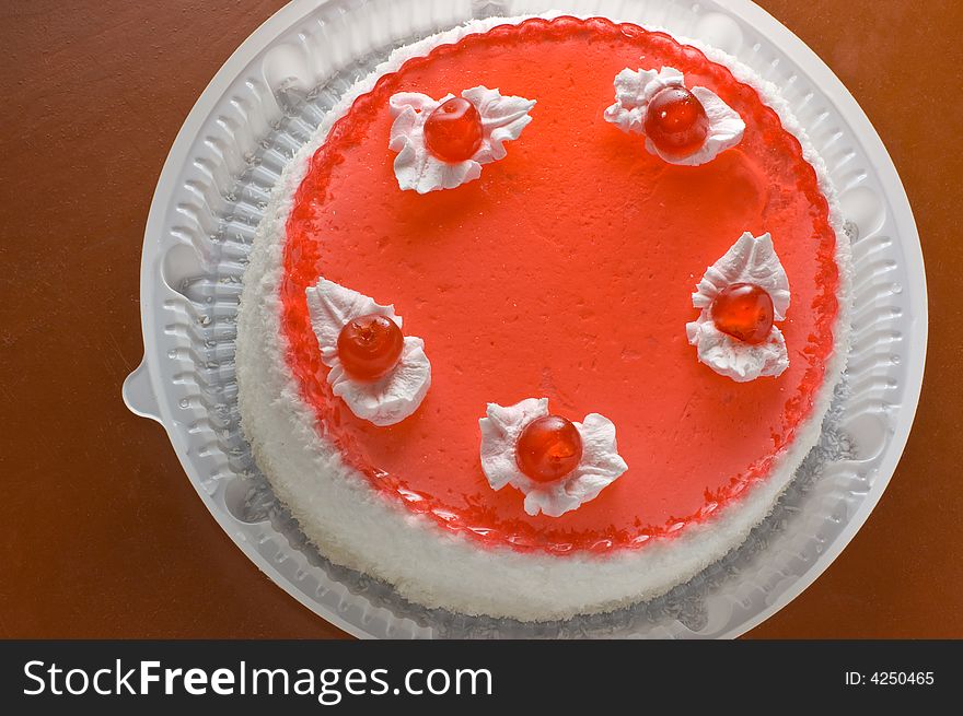 Tart with cherries on brown background