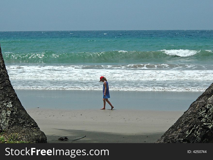 Girl Strolling Along An Empty Beach
