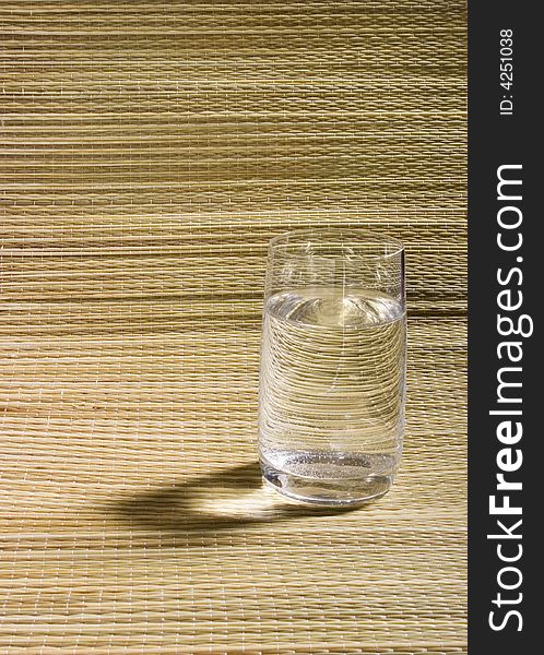 Glass Of Water On Wicker Background