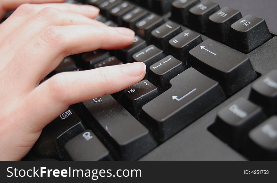 Hands typing on a black keyboard. Hands typing on a black keyboard
