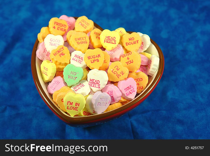 A picture of a bowl of colorful sweethearts. A picture of a bowl of colorful sweethearts