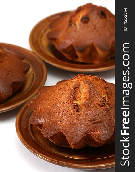 Appetizing fruitcakes with raisin on ceramic plate