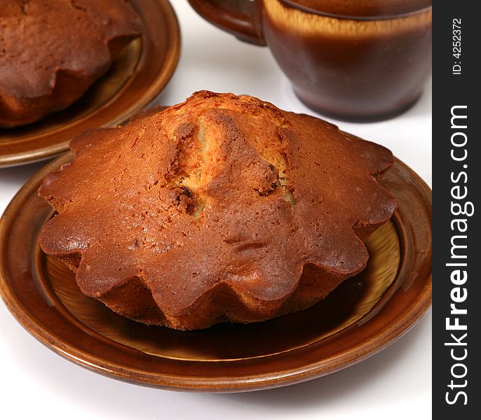 Appetizing fruitcakes with raisin on ceramic plate