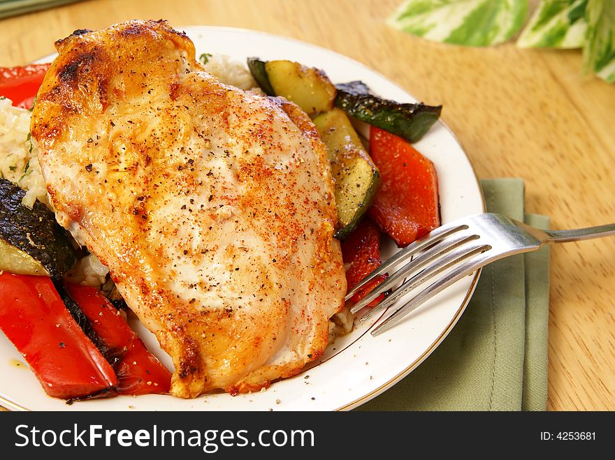 Broiled chicken breast with cayenne and cracked black pepper, served with zucchini, red bell peppers, and wild brown rice. Broiled chicken breast with cayenne and cracked black pepper, served with zucchini, red bell peppers, and wild brown rice.