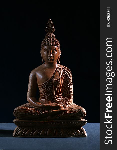Figurine wood buddha on black Background