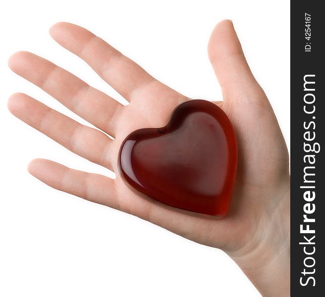 Glassy heart on the woman's palm isolated at the white background