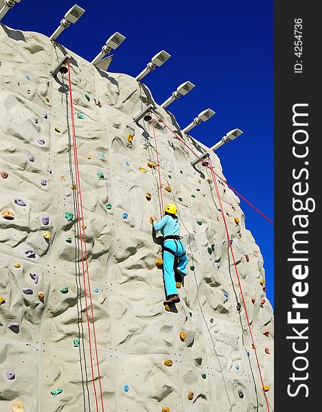 Woman climing a rock wall. Woman climing a rock wall