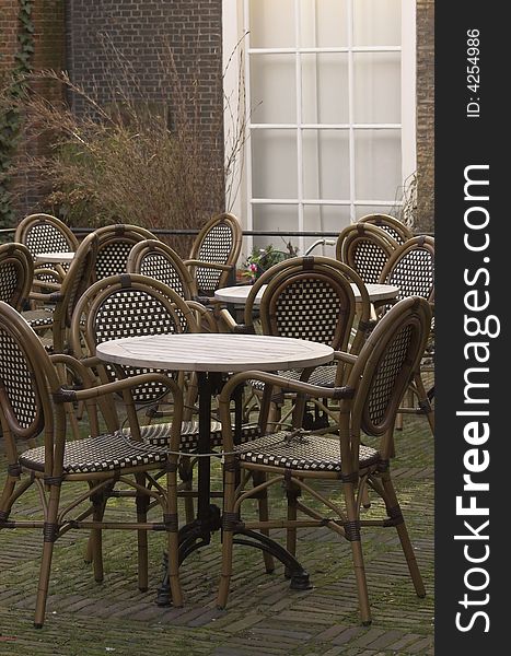 Cafe terrace, a table and a set of rattan chairs, photo taken in Delft, Holland