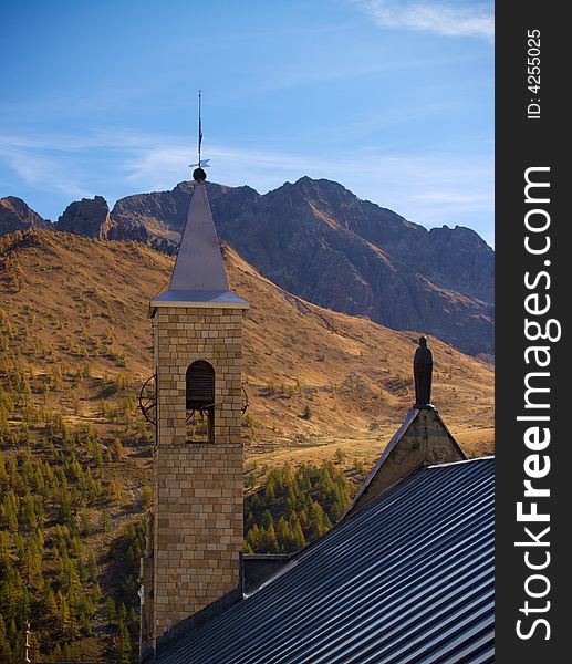 An unusual view of old church with mountains in the background and warm light. An unusual view of old church with mountains in the background and warm light