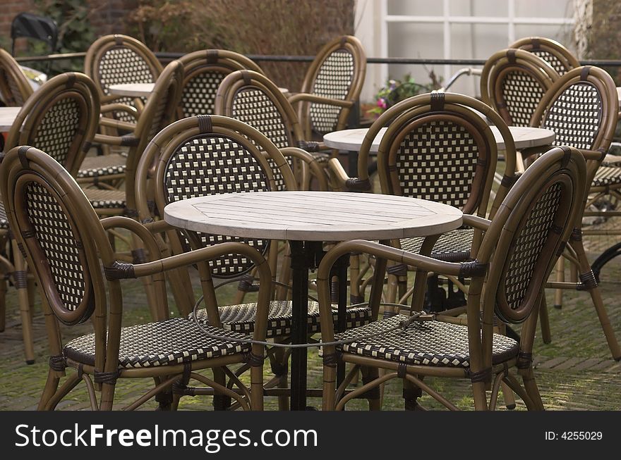 Cafe terrace, a table and a set of rattan chairs, photo taken in Delft, Holland