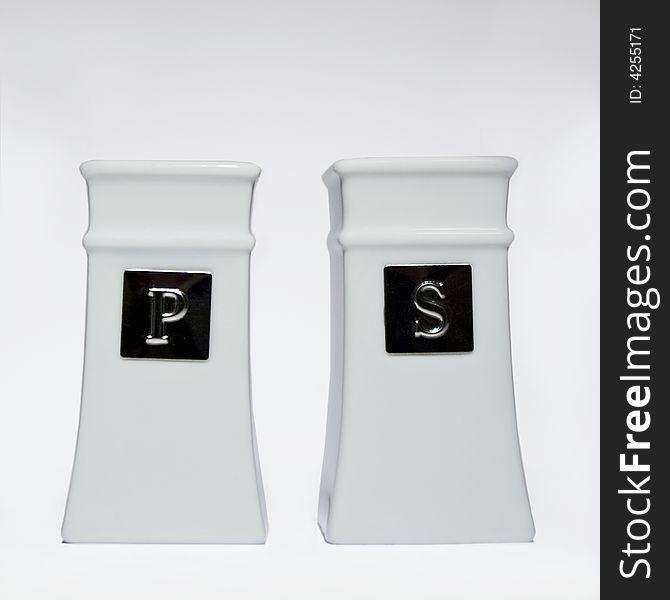 Salt and pepper shakers with a white background. Salt and pepper shakers with a white background