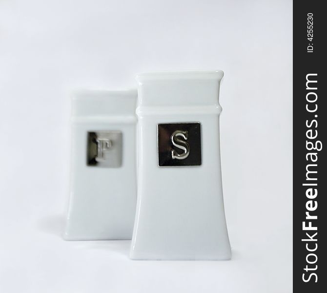 Salt and pepper shakers with a white background. Salt and pepper shakers with a white background