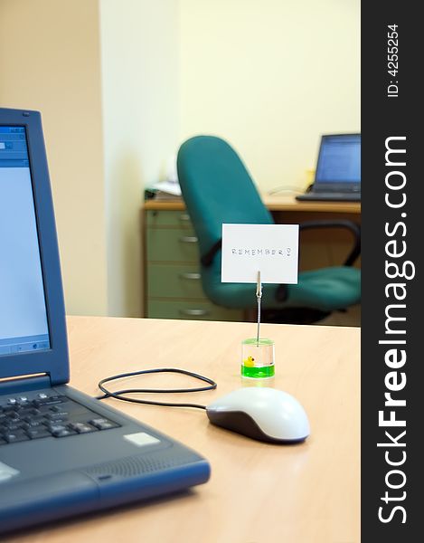 Office desk with laptop computer and reminder note. Office desk with laptop computer and reminder note.