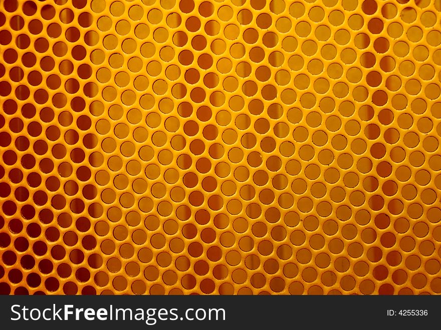 Yellow painted metal grill on the front of a tractor. Yellow painted metal grill on the front of a tractor