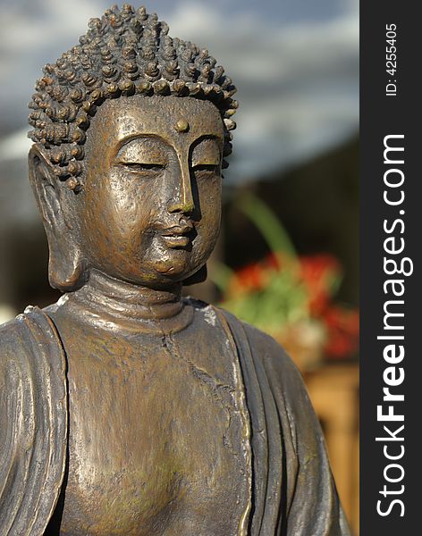 Bronze buddha in front of a vague background. Bronze buddha in front of a vague background.