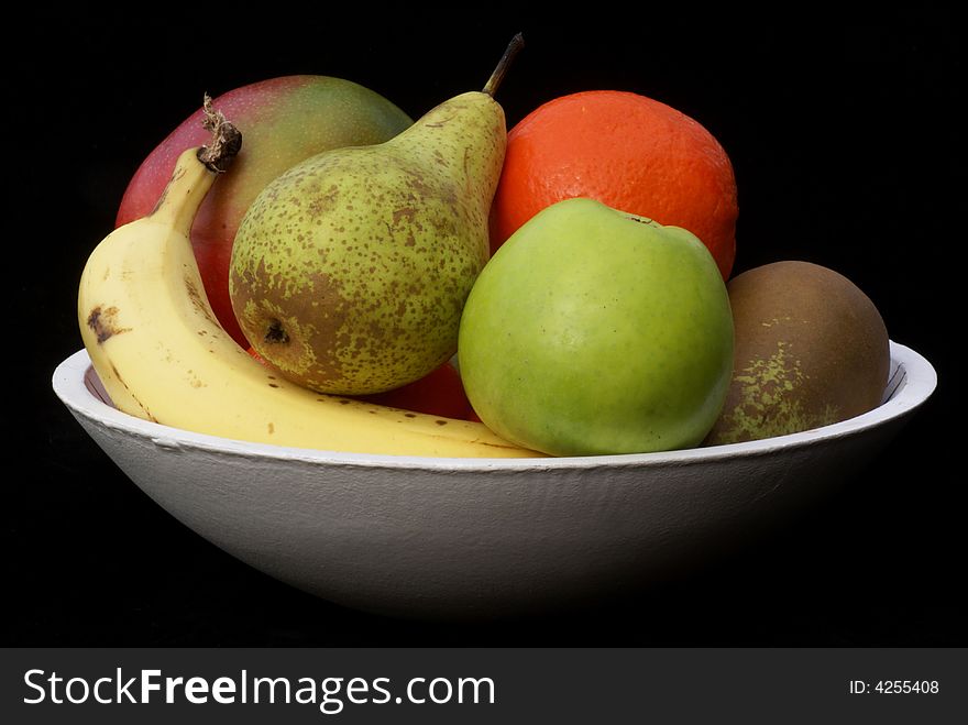 Bowl with fruit isolated on a black background. Bowl with fruit isolated on a black background.