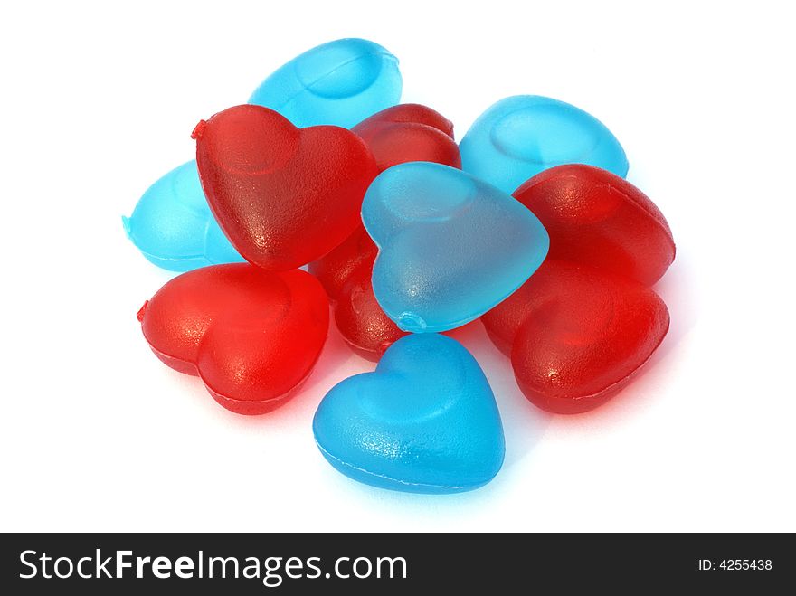 Red and blue heart shaped ice cubes, isolated on a white background. Red and blue heart shaped ice cubes, isolated on a white background.