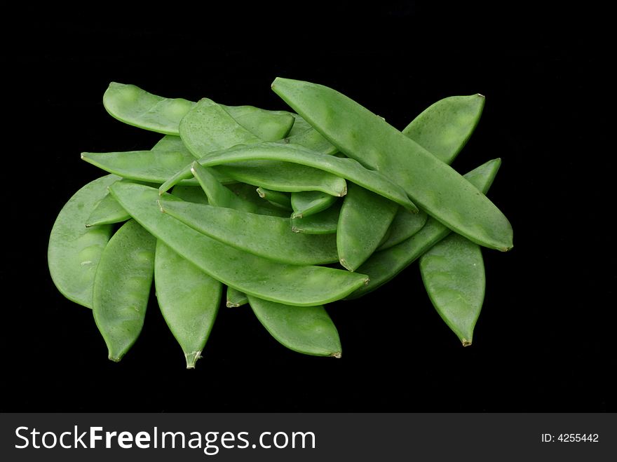 Podded peas isolated on a black background. Podded peas isolated on a black background.