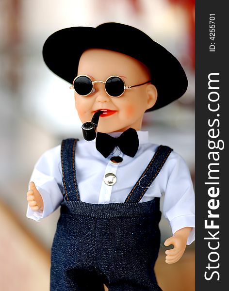 A chinese plastic doll, a boy with shirt, pants,dark sunglasses,cigrette pipe. A chinese plastic doll, a boy with shirt, pants,dark sunglasses,cigrette pipe.