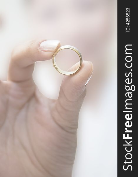 Wedding ring held by bride