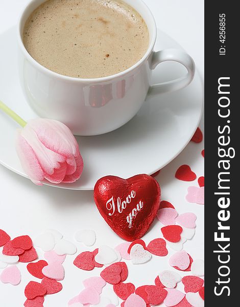Coffee cup with heart and pink tulip on white background. Coffee cup with heart and pink tulip on white background.