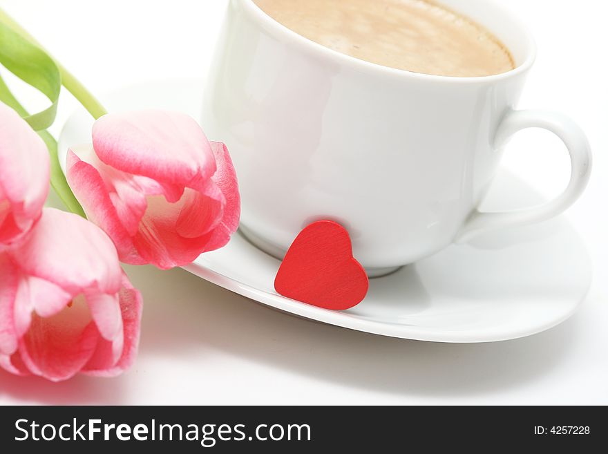 Coffee cupwith coffee,small red heart and pink tulip. Coffee cupwith coffee,small red heart and pink tulip.