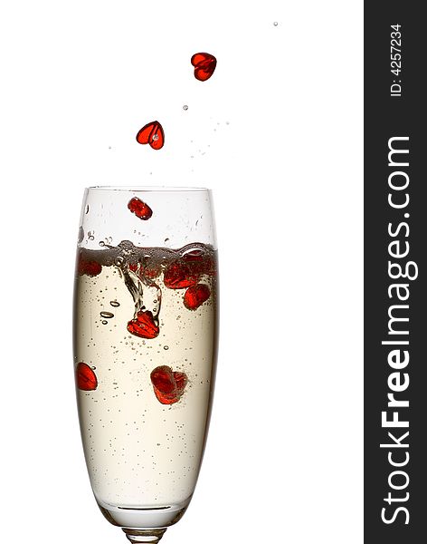 Hearts falling down into champagne flute. Hearts falling down into champagne flute.