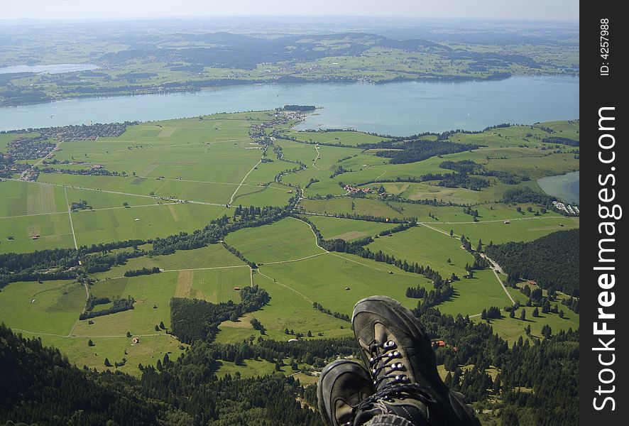 View to the lake Forggensee during a flight with a paraglider from the mountain Tegelberg near Neuschwanstein, Bavaria, Germany. Altitude ca. 500 meters. View to the lake Forggensee during a flight with a paraglider from the mountain Tegelberg near Neuschwanstein, Bavaria, Germany. Altitude ca. 500 meters.