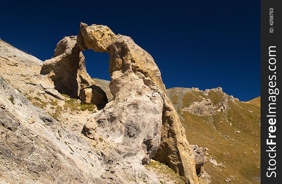 Strange mountain rock with an unusual shape and a deep blue sky