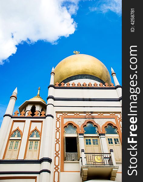 Historical mosque in the historic Malay district in Singapore, against a bright blue partly cloudy morning sky. Historical mosque in the historic Malay district in Singapore, against a bright blue partly cloudy morning sky.
