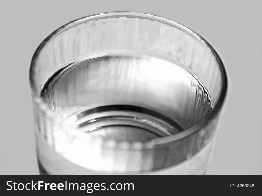 Single glass of water black and white macro